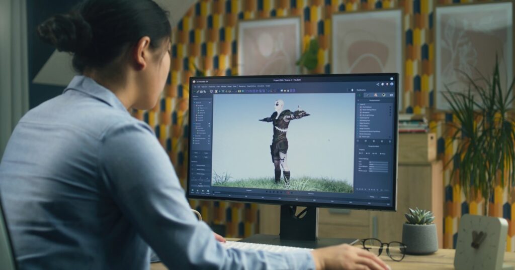 A woman, a 3D animator, intently works on her computer