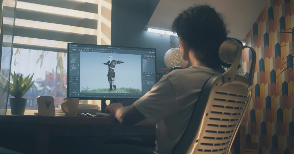  Person at desk with computer screen for 3D online course.