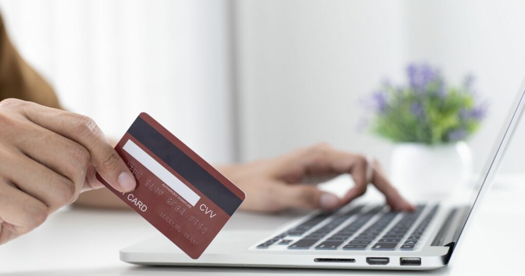 Person holding credit card for online payment