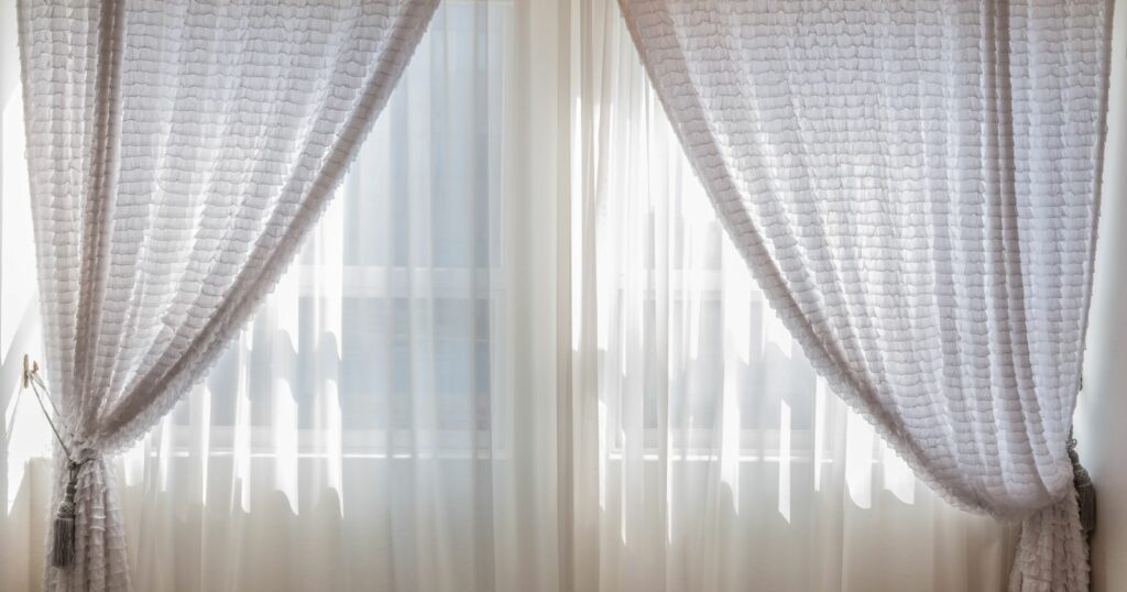 Grommet window curtain with elegant curtains and a curtain rod.