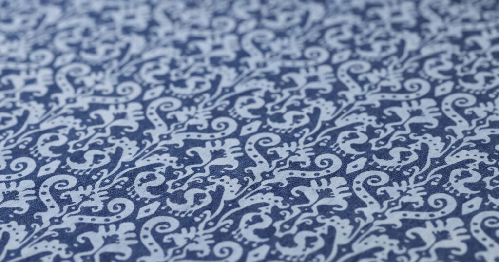 Blue and white patterned linen draperies up close.