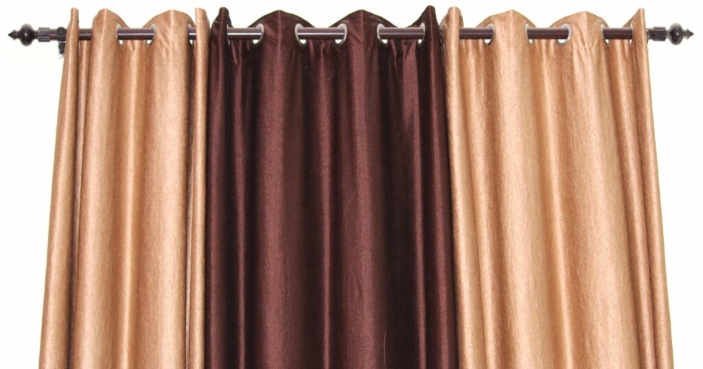 A curtain with a blend of brown, beige, and gold colors, adding warmth and elegance to any space.