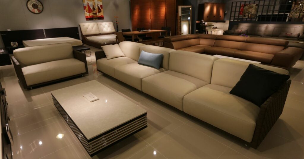 Spacious living room with modern couch, coffee table, and chairs