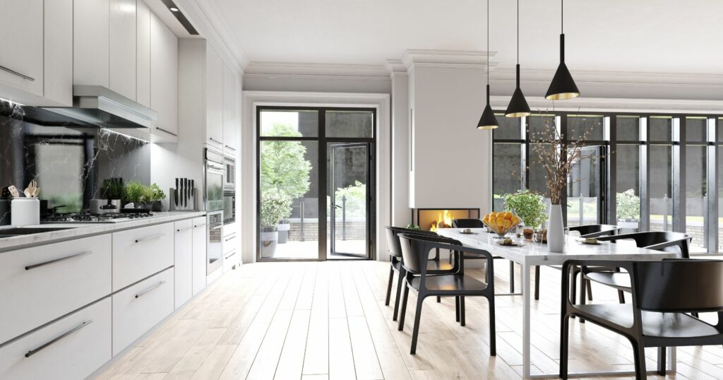 Contemporary kitchen featuring white cabinets and black chairs, showcasing modern furniture 