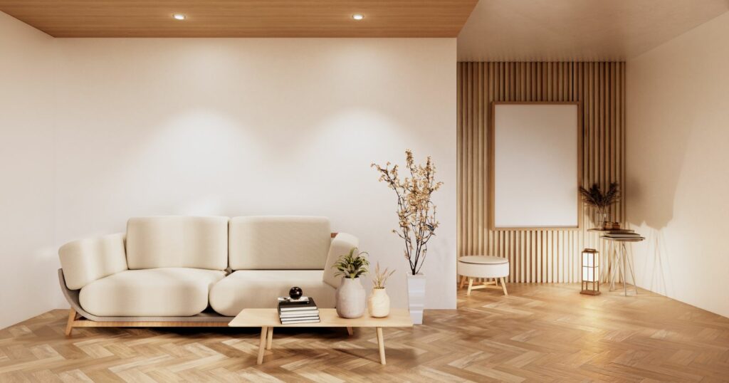 Modern white couch on wooden floor in a stylish living room.