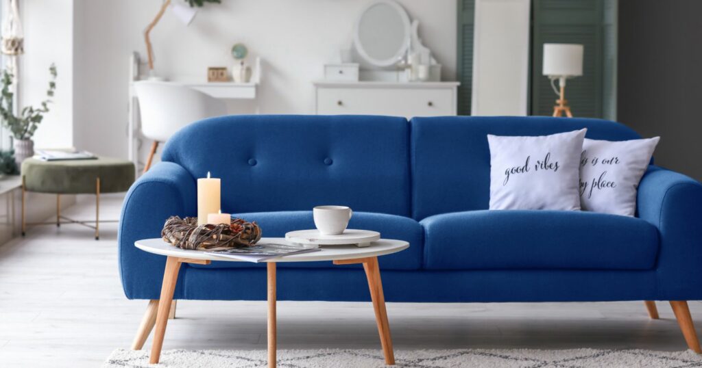 Customizable modern blue sofa and coffee table in living room.