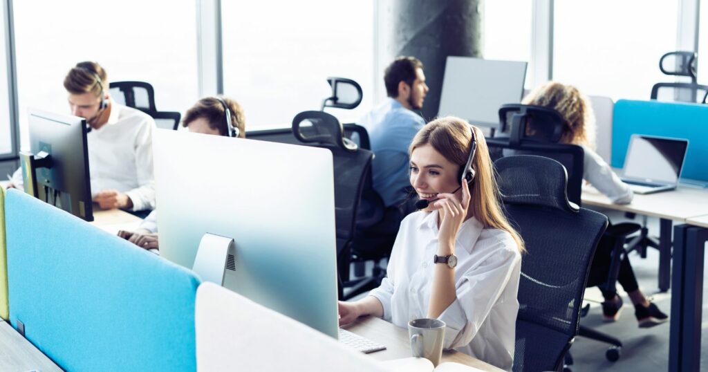 Group of people in an office, working at a call center.