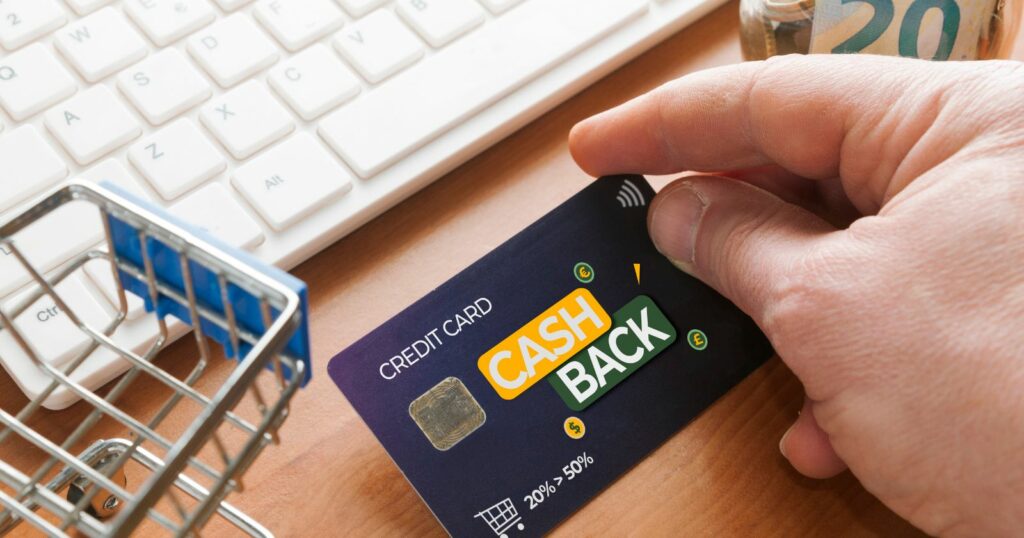 A laptop displaying a website with the words "Cash Back" highlighted. A hand holding a credit card is shown, symbolizing online purchases.