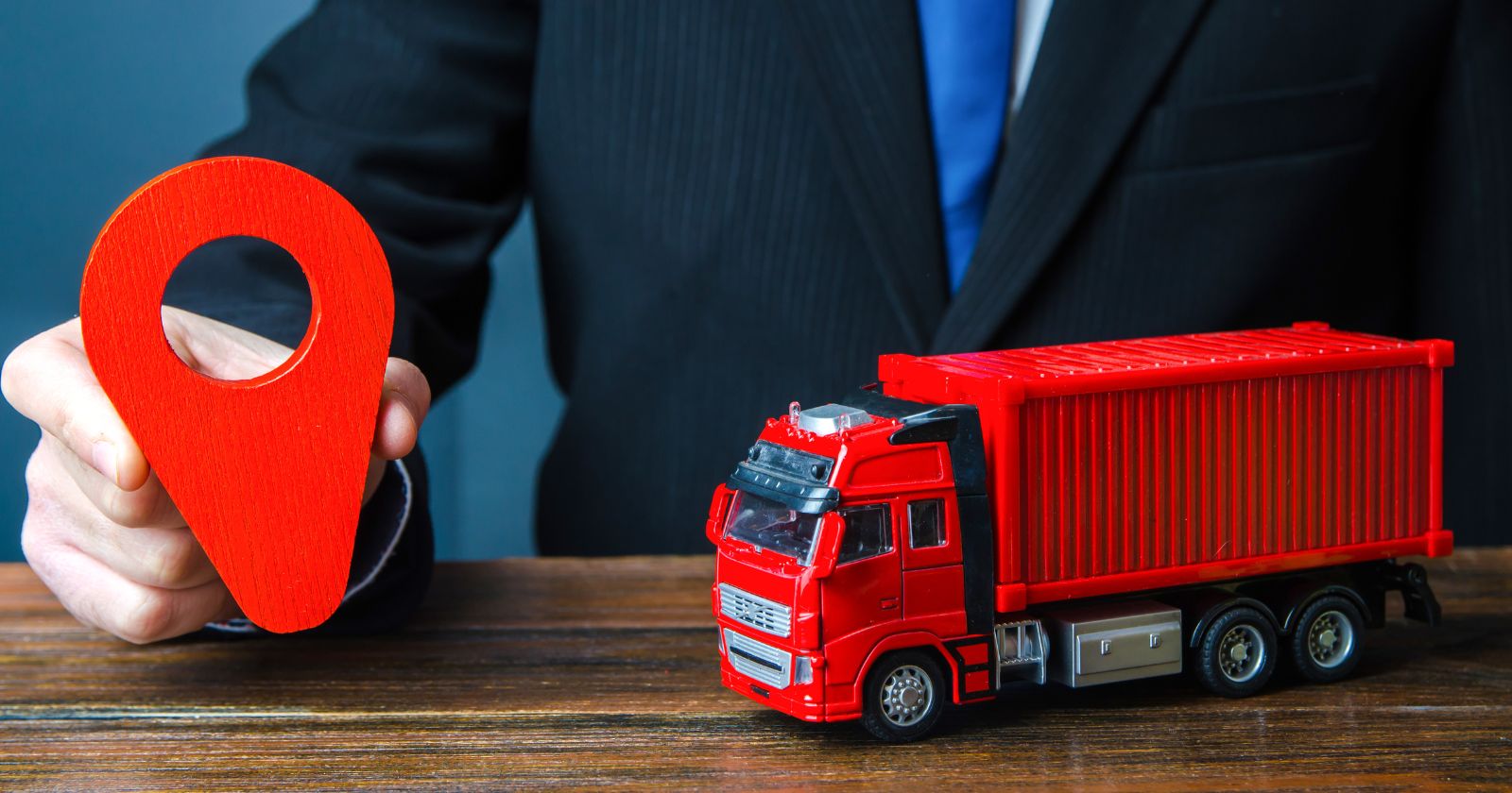 A person holding a magnifying glass, examining a list of trucking companies. Keywords: 'how to choose the right trucking company'. Additional information: 'Commercial Moving Companies SEO'.