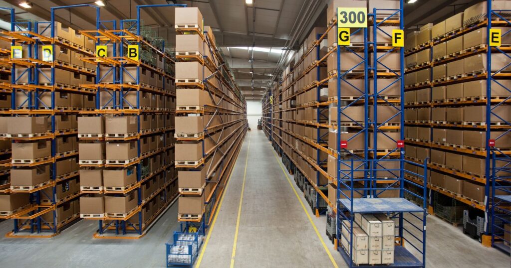 A large warehouse with numerous boxes and shelves showcasing Innovative Storage Solutions.