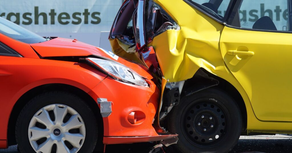 Two damaged cars after an accident, highlighting the importance of comprehensive coverage.