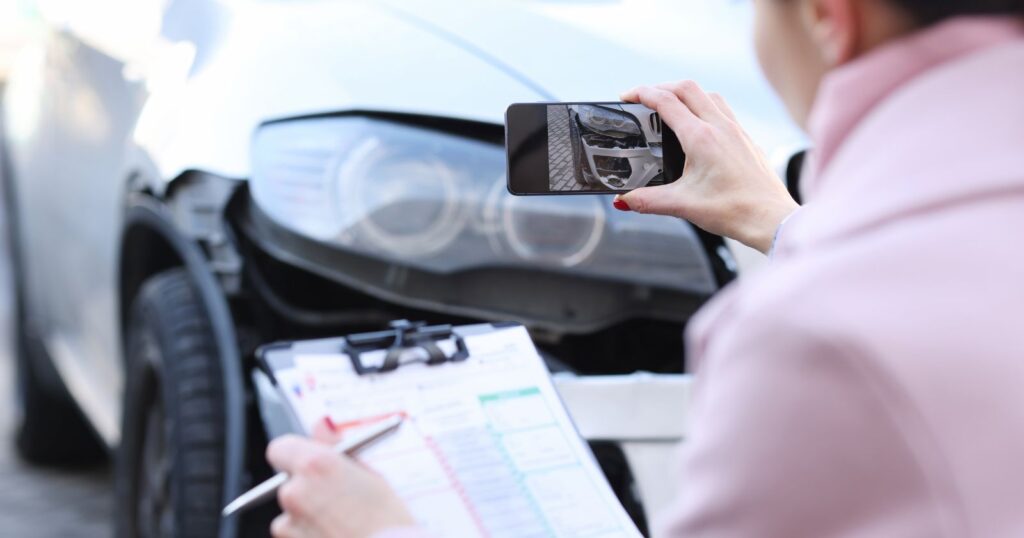 A woman holding a clipboard, examining a car. Image for 'Estimate Your Car Insurance'.