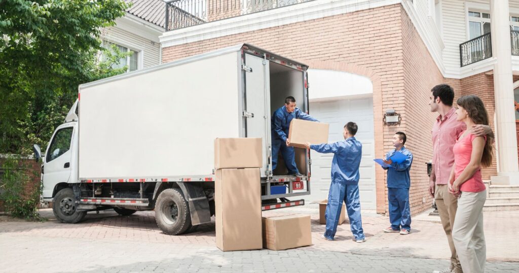 Professional movers transporting furniture and boxes. The Impact of Tipping on Movers.