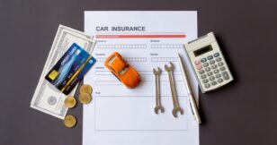 Car insurance and tools on a desk: A desk displaying car insurance documents and various tools used for car maintenance.