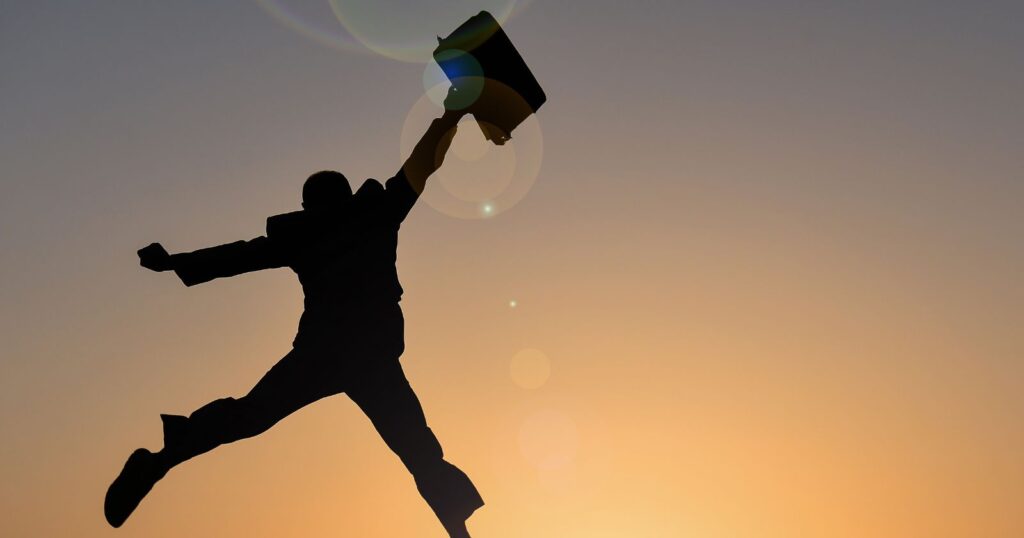 A man leaps into the air with a laptop, symbolizing "Expanding Your Horizons".